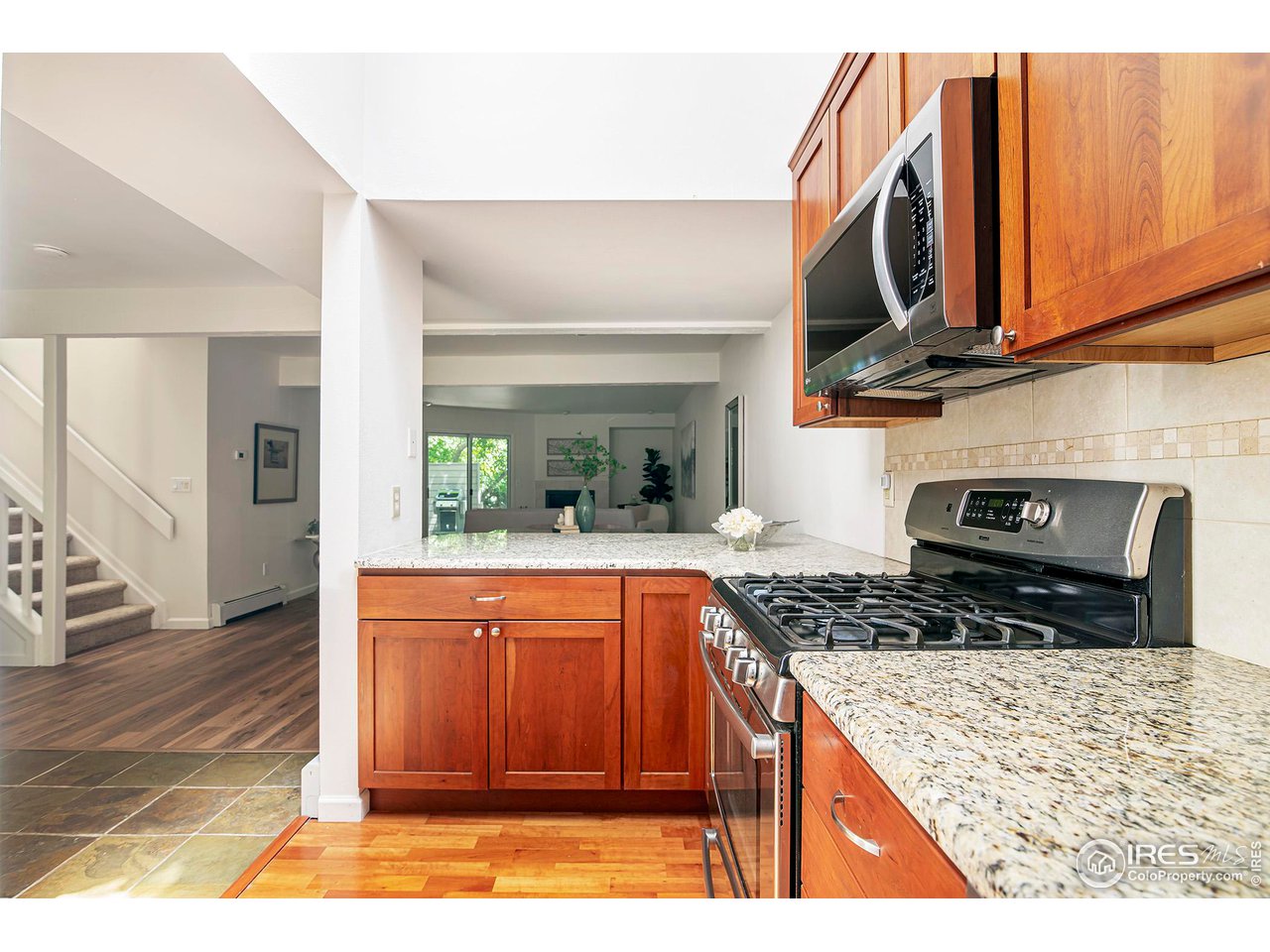 3054 Edison Court Boulder, CO 80301 - Photo 12 of 36 a kitchen with stainless steel appliances granite countertop a stove a sink and a microwave