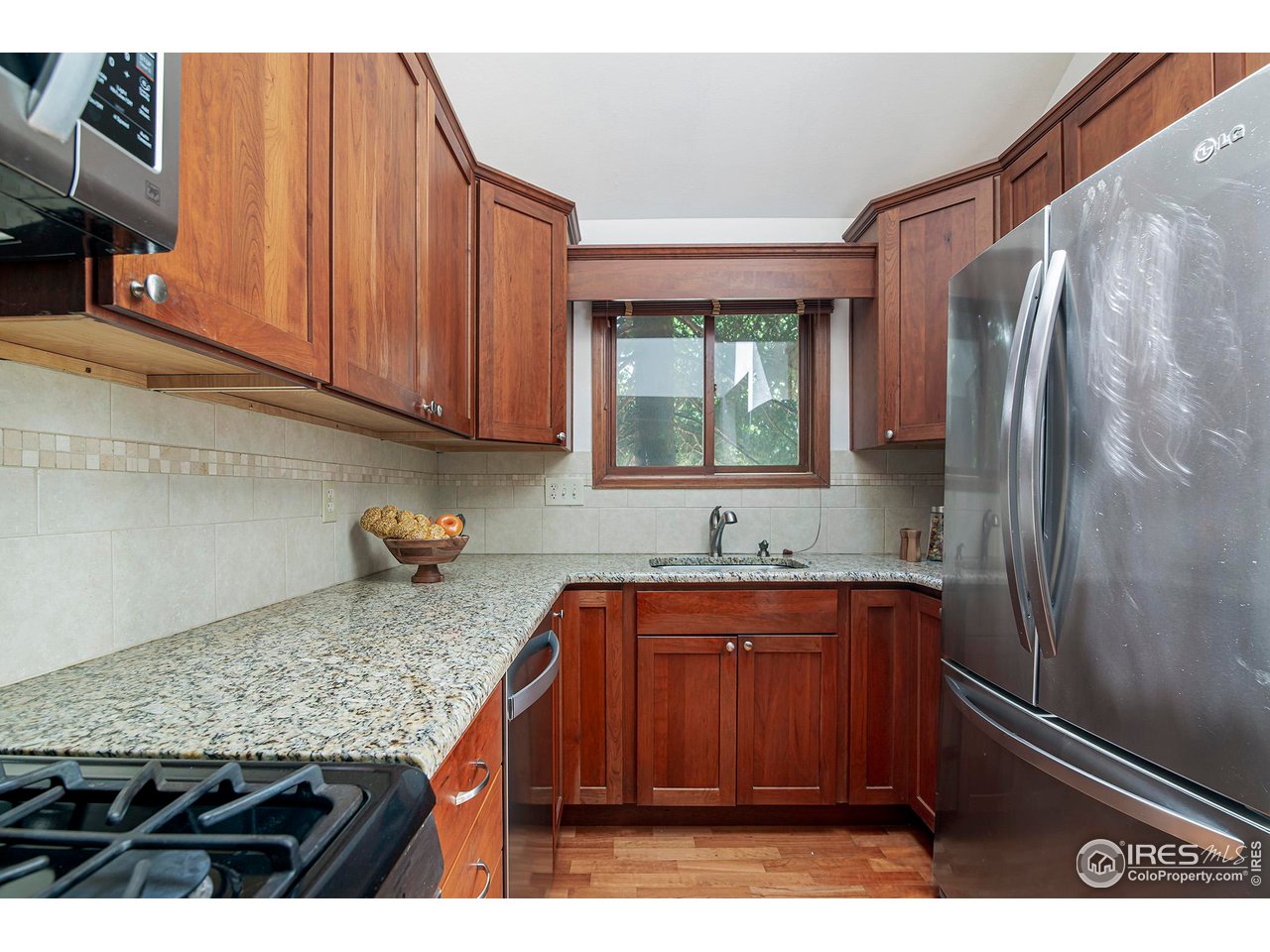 3054 Edison Court Boulder, CO 80301 - Photo 13 of 36 a kitchen with stainless steel appliances granite countertop a sink stove and refrigerator