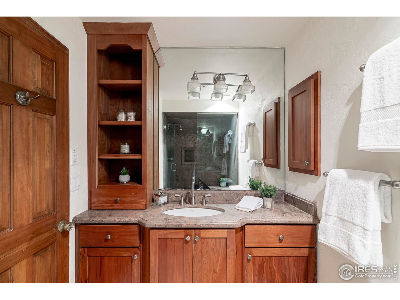 3054 Edison Court Boulder, CO 80301 - Photo 17 of 36 a bathroom with a sink a vanity and a large mirror