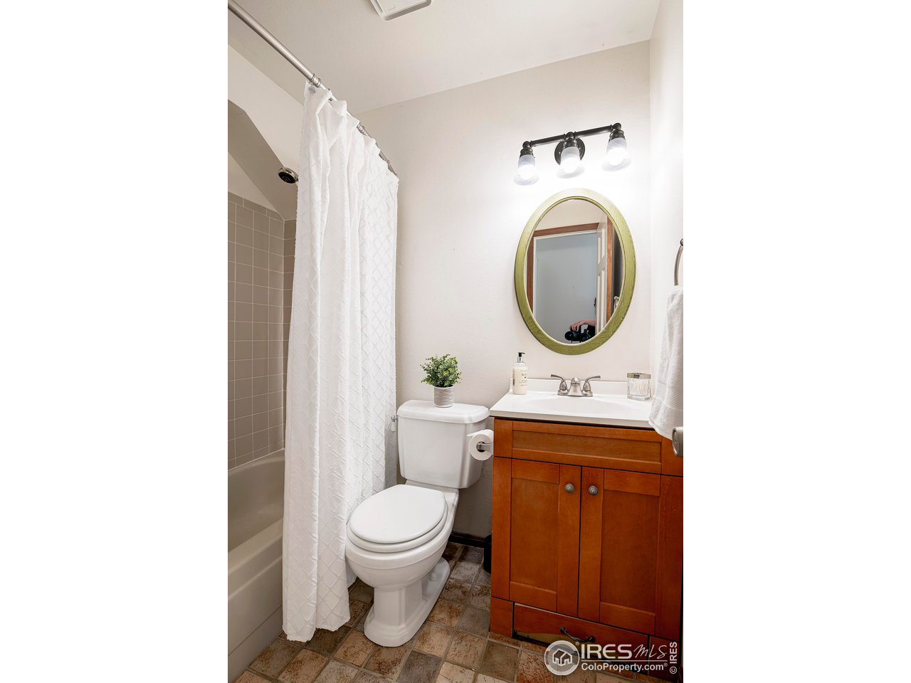 3054 Edison Court Boulder, CO 80301 - Photo 27 of 36 a bathroom with a toilet sink and mirror
