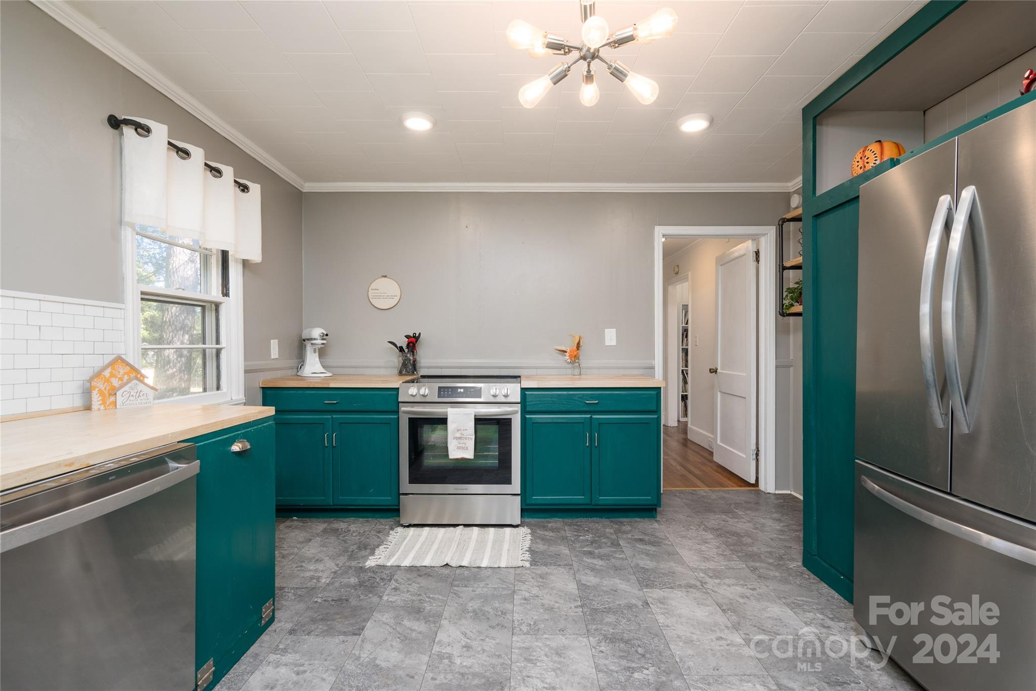 2176 Old Hickory Grove Road Mount Holly, NC 28120 - Photo 12 of 34 a kitchen with stainless steel appliances kitchen island granite countertop a refrigerator and a sink
