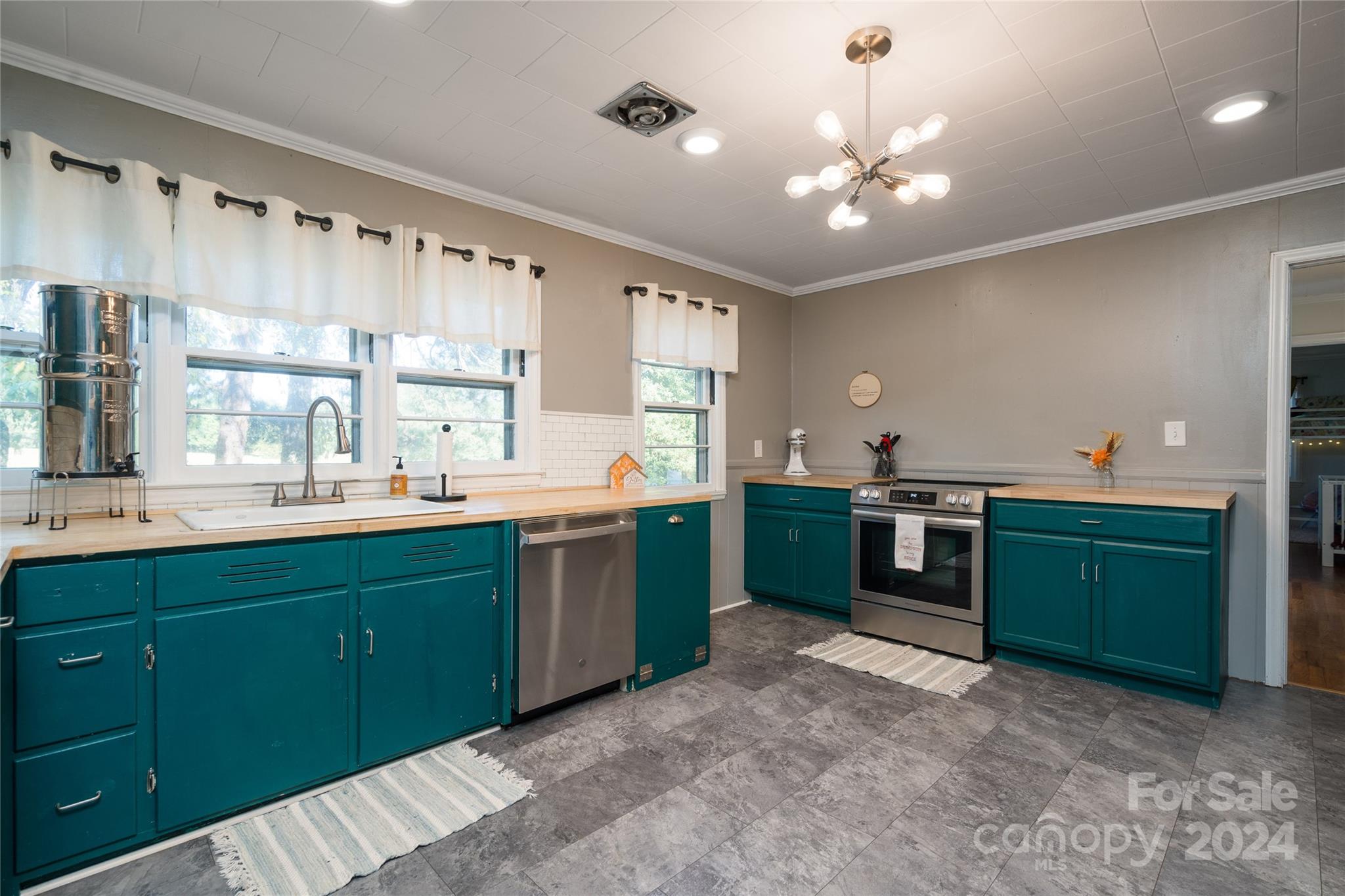 2176 Old Hickory Grove Road Mount Holly, NC 28120 - Photo 14 of 34 a kitchen with kitchen island granite countertop a sink cabinets and stainless steel appliances