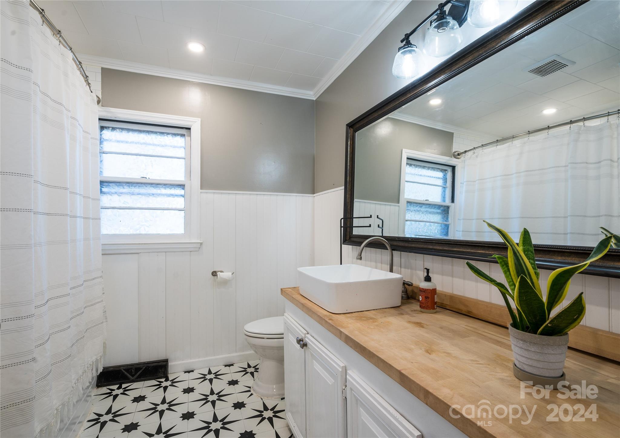 2176 Old Hickory Grove Road Mount Holly, NC 28120 - Photo 22 of 34 a bathroom with a granite countertop sink a toilet and a mirror