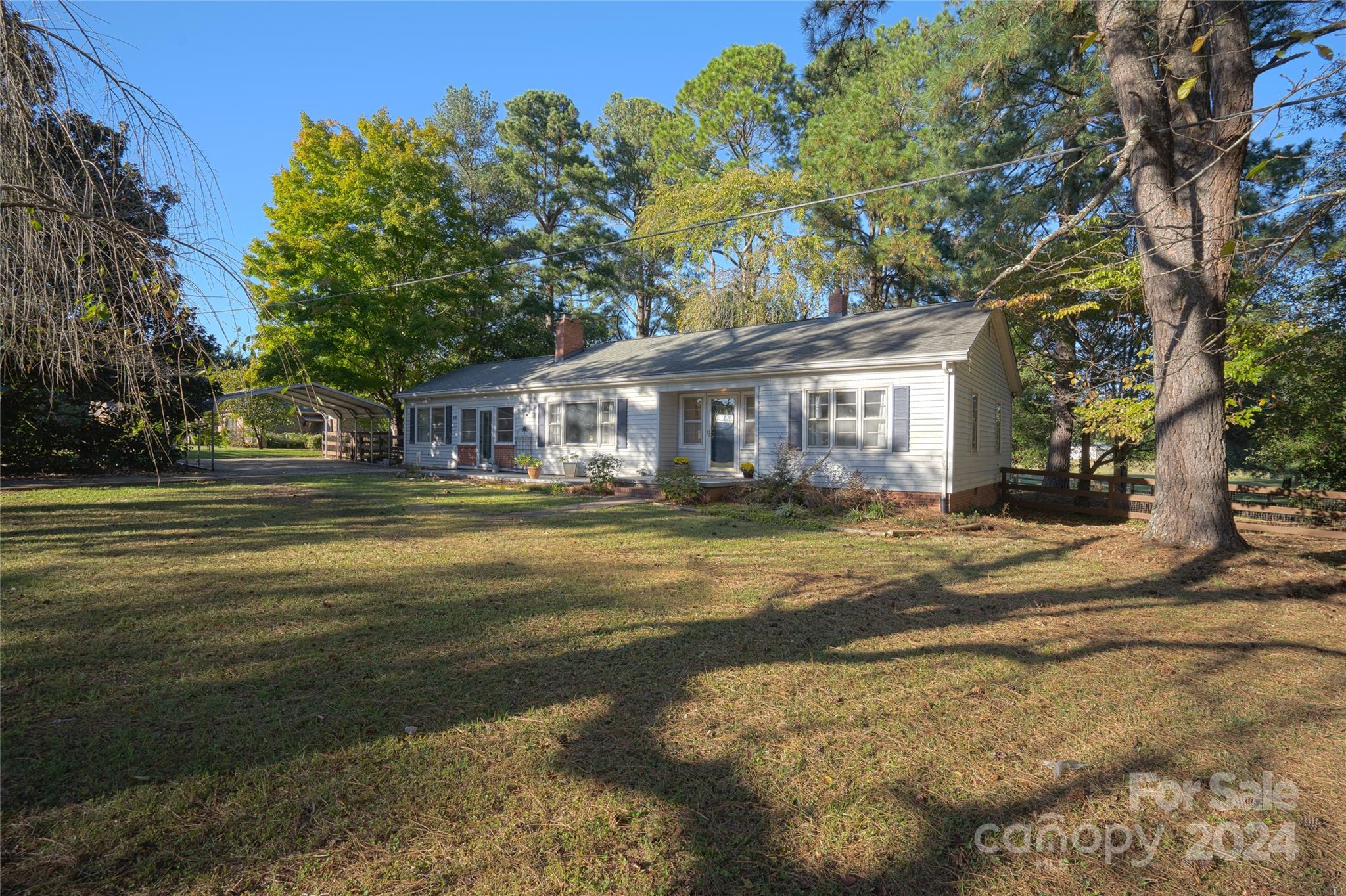 2176 Old Hickory Grove Road Mount Holly, NC 28120 - Photo 4 of 34 a view of a house with a big yard and large trees