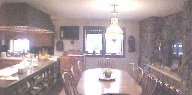 1262 East Brick Road Oregon, IL 61061 - Photo 2 of 6 a dining room with wooden floor a chandelier a wooden table and chairs