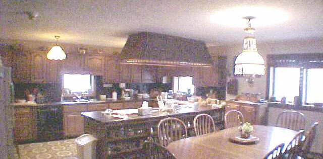 1262 East Brick Road Oregon, IL 61061 - Photo 3 of 6 a dining room with granite countertop lots of wooden furniture