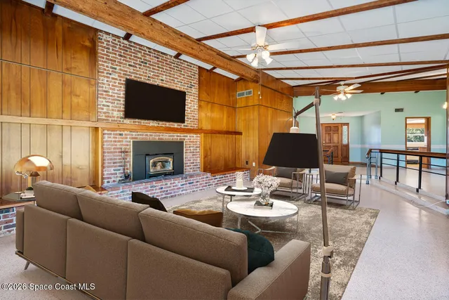 a view of a livingroom with a ceiling fan and window