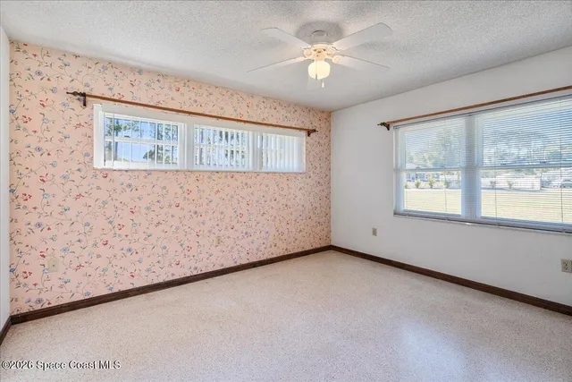 a view of a hallway with furniture and a window