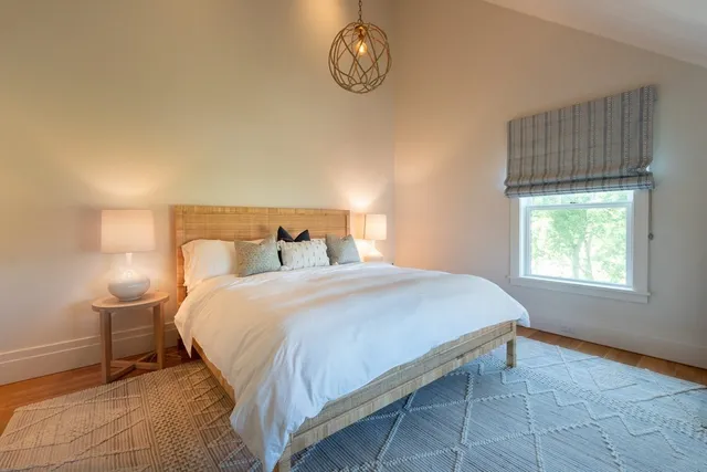 a bedroom with a bed and window