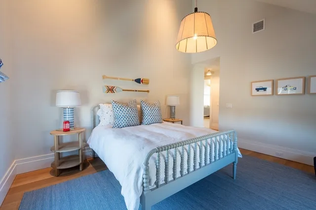 a bedroom with a bed and a chandelier