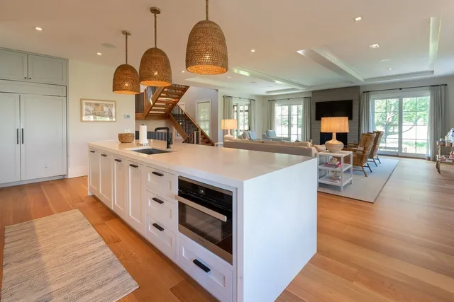 a kitchen with stainless steel appliances granite countertop a stove and a wooden floors