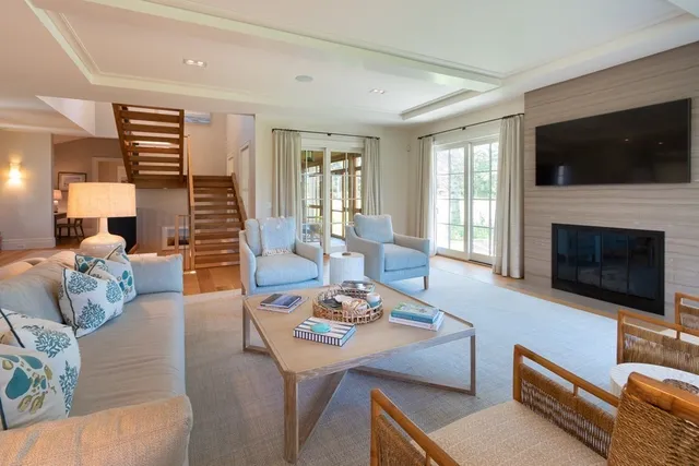 a living room with furniture fireplace and flat screen tv