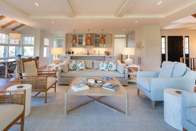 a living room with furniture kitchen and a table