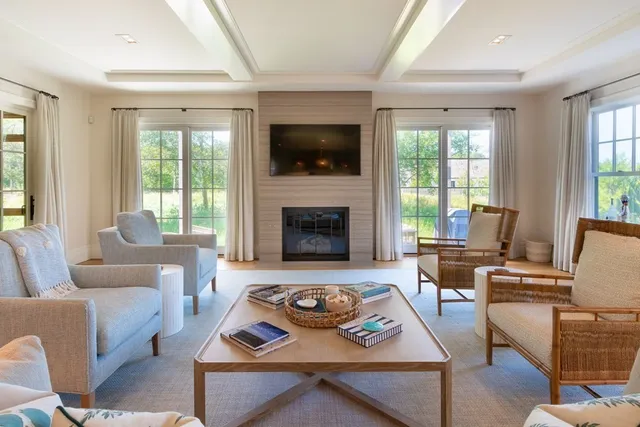 a living room with furniture fireplace and flat screen tv