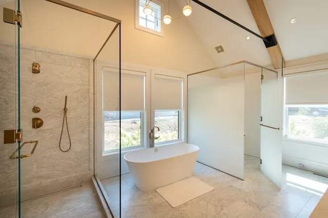 a bathroom with a tub and a shower