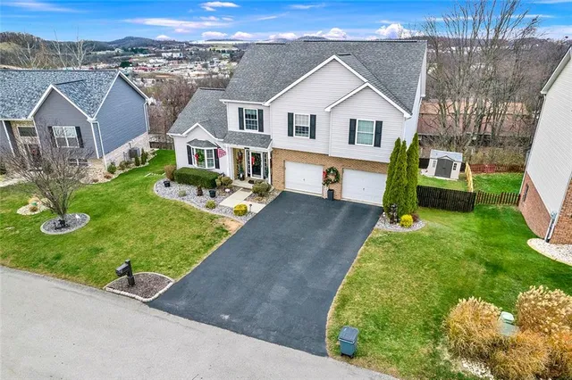 an aerial view of a house with a garden and plants