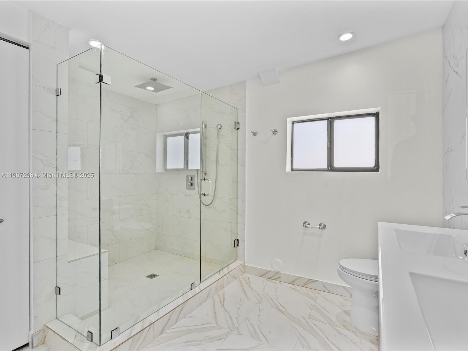 19461 Northeast 22nd Road North Miami Beach, FL 33179 - Photo 14 of 34 a bathroom with a shower and a toilet