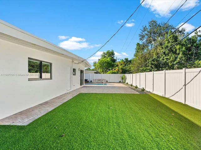 a view of yard with swimming pool and sitting area