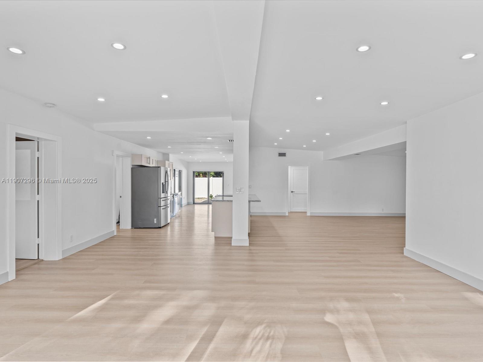 19461 Northeast 22nd Road North Miami Beach, FL 33179 - Photo 7 of 34 a view of an empty room with wooden floor
