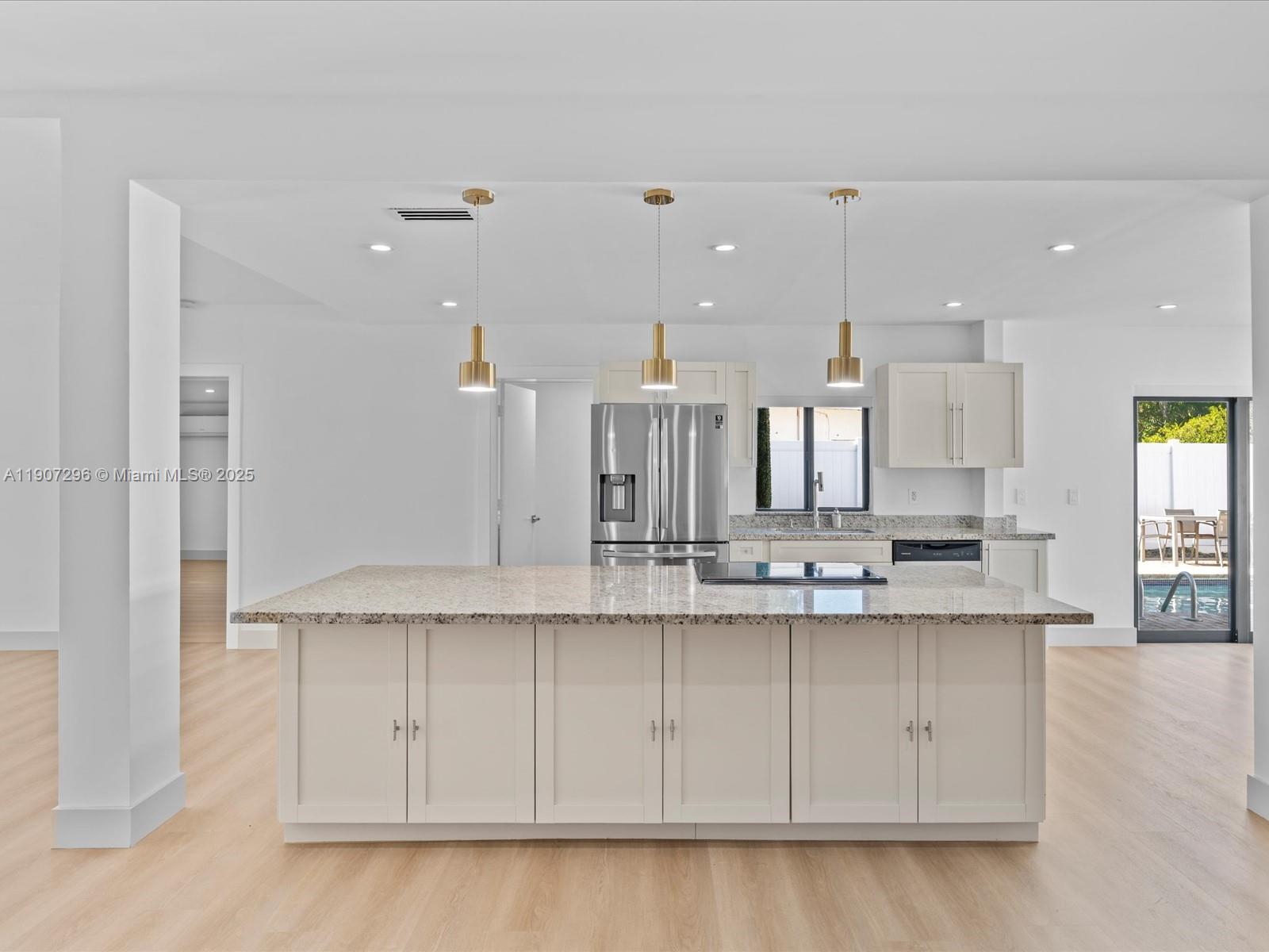 19461 Northeast 22nd Road North Miami Beach, FL 33179 - Photo 8 of 34 a kitchen with stainless steel appliances granite countertop a sink a stove and a refrigerator