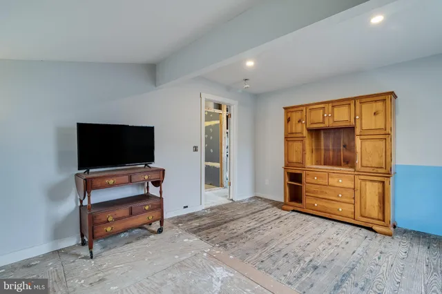 a bedroom with furniture and flat screen tv