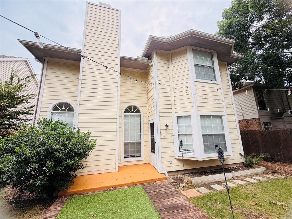434 Moonlight Way Irving, TX 75063 - Photo 25 of 29 a view of a white house with large windows next to a yard