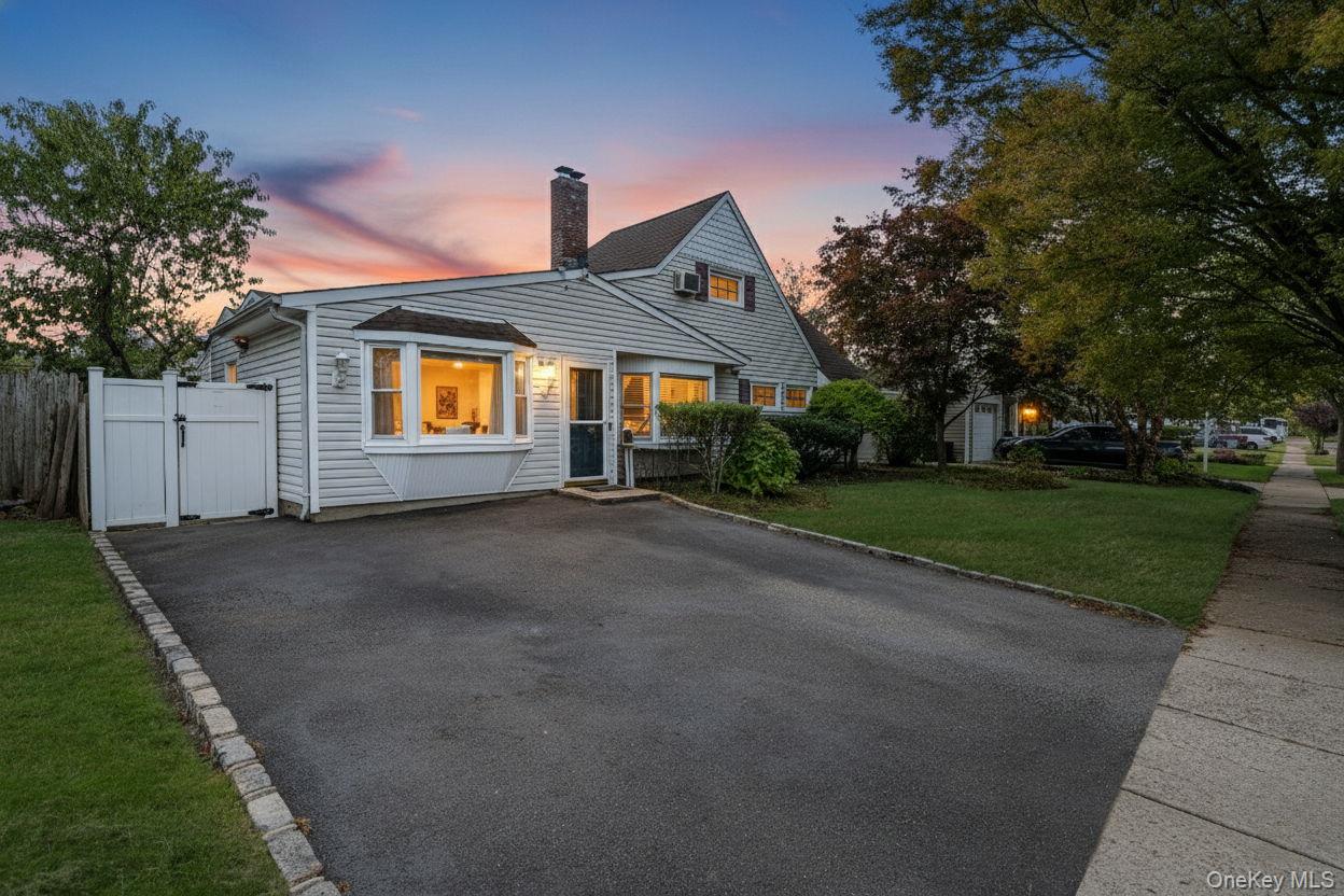 95 Lantern Road Hicksville, NY 11801 - Photo 2 of 36 a front view of a house with a yard and garage