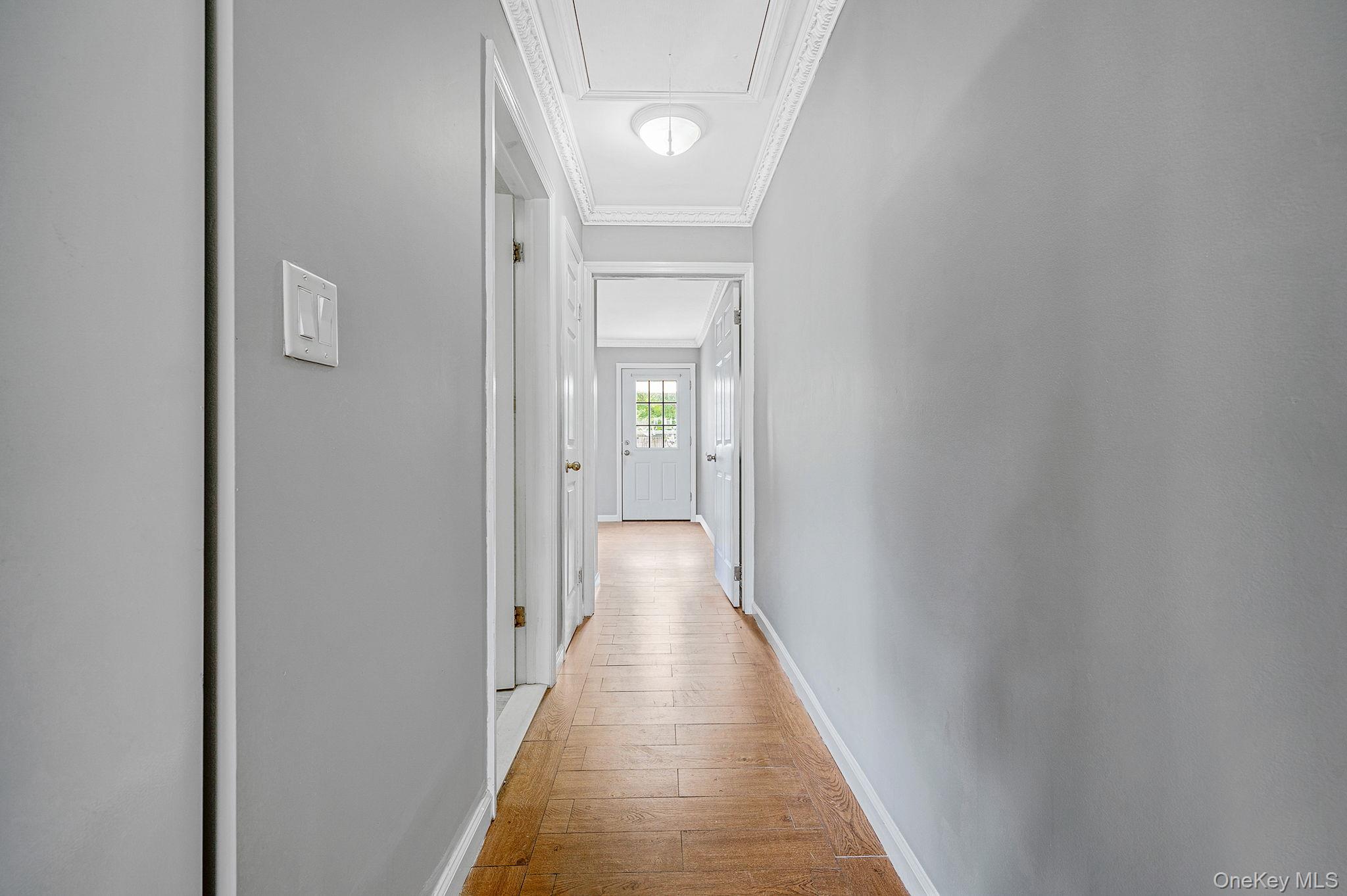 95 Lantern Road Hicksville, NY 11801 - Photo 31 of 36 a view of a hallway with wooden floor