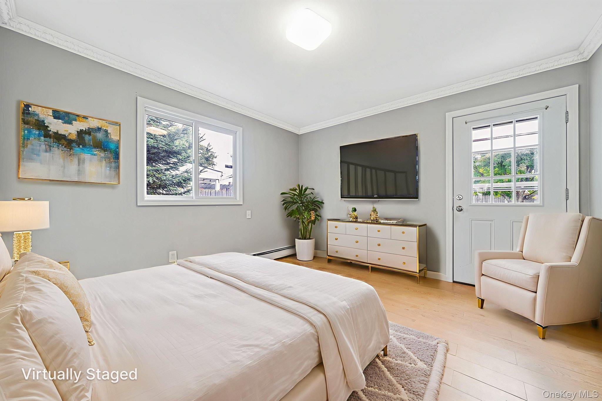 95 Lantern Road Hicksville, NY 11801 - Photo 32 of 36 a bedroom with a bed a couch and a flat screen tv