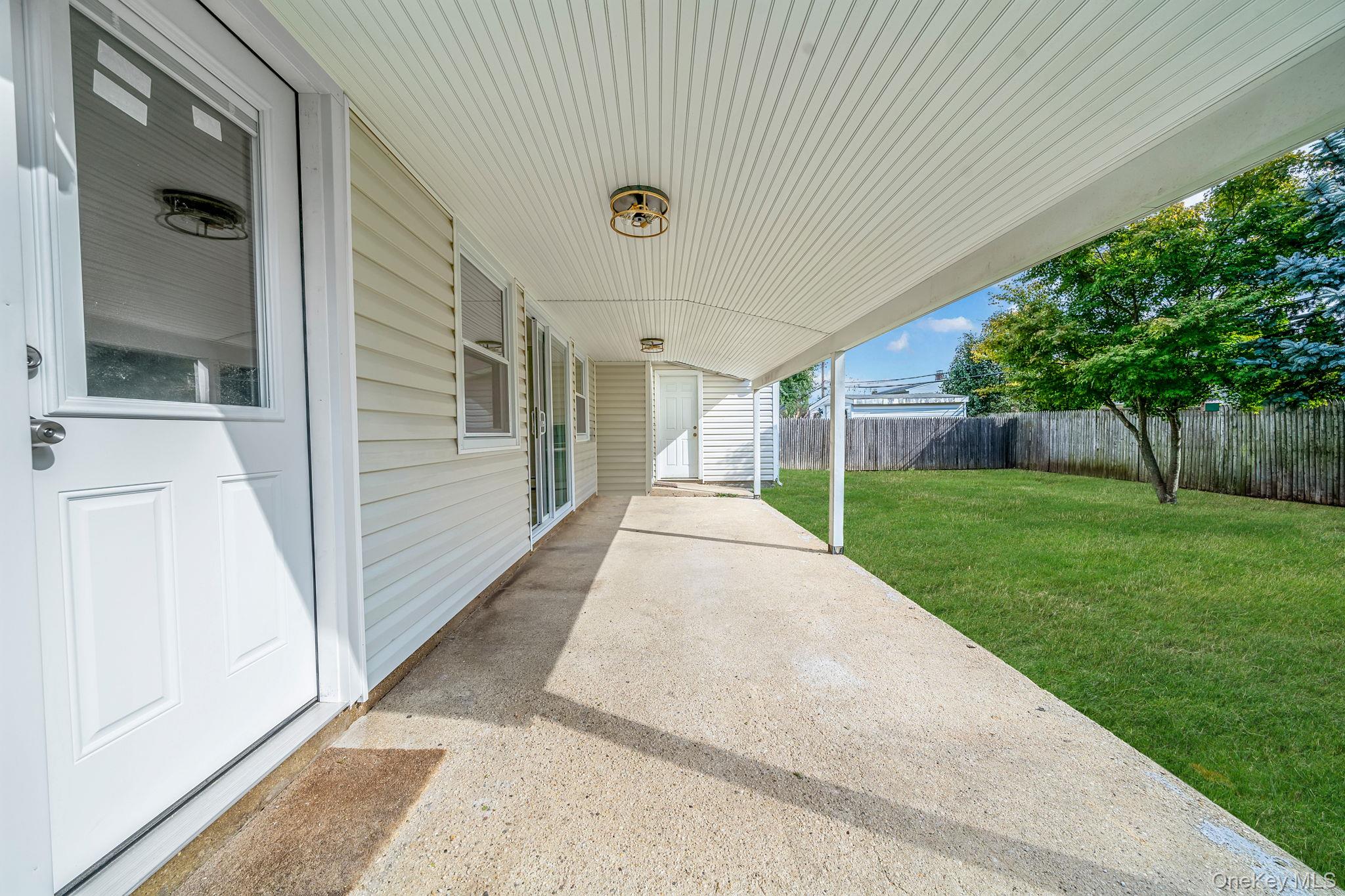 95 Lantern Road Hicksville, NY 11801 - Photo 33 of 36 a view of a porch with a garden