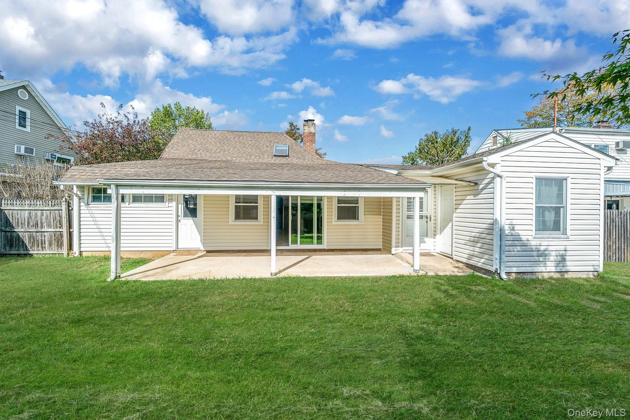 95 Lantern Road Hicksville, NY 11801 - Photo 34 of 36 a view of a house with a yard and sitting area
