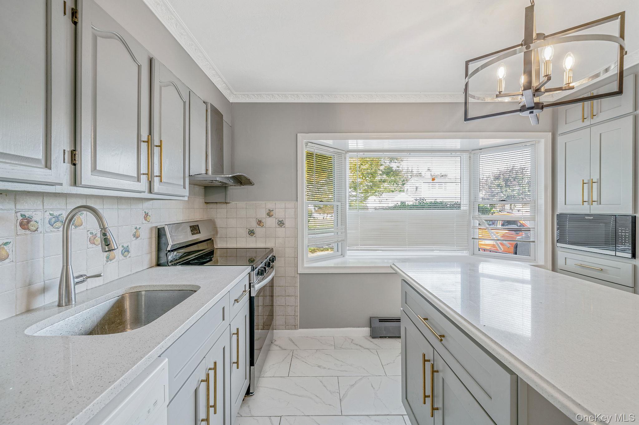 95 Lantern Road Hicksville, NY 11801 - Photo 5 of 36 a kitchen that has a sink and a stove
