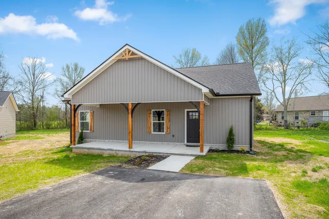 a front view of house with yard and green space