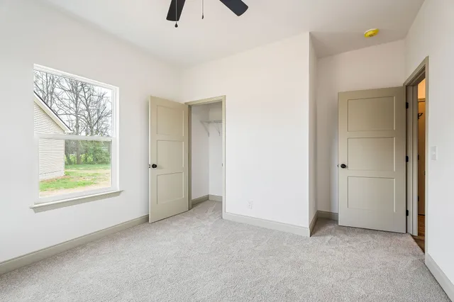 an empty room with windows and closet