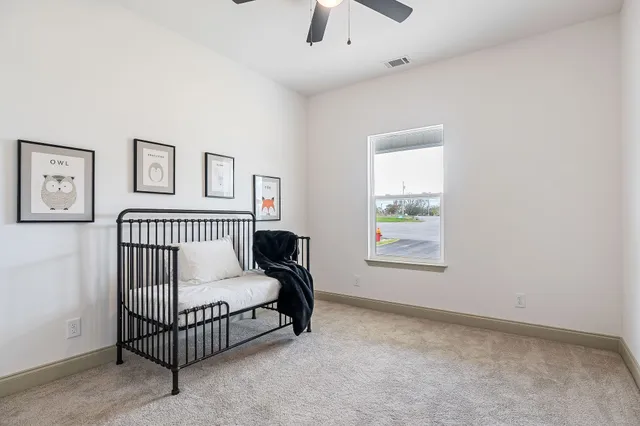 a spacious bedroom with a bed and a window