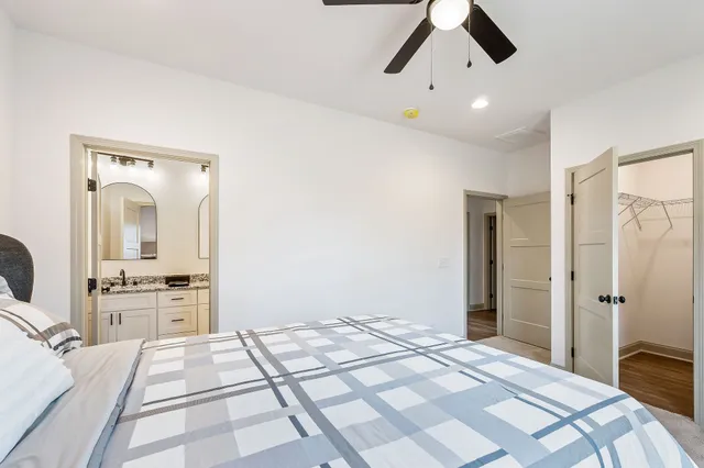 a bedroom with a bed and a chandelier