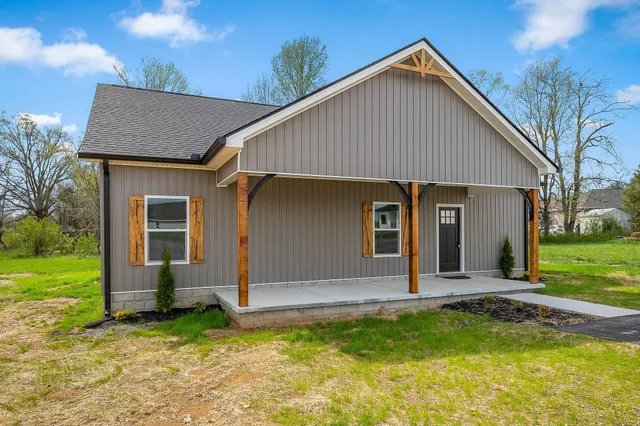 a front view of house with yard and green space
