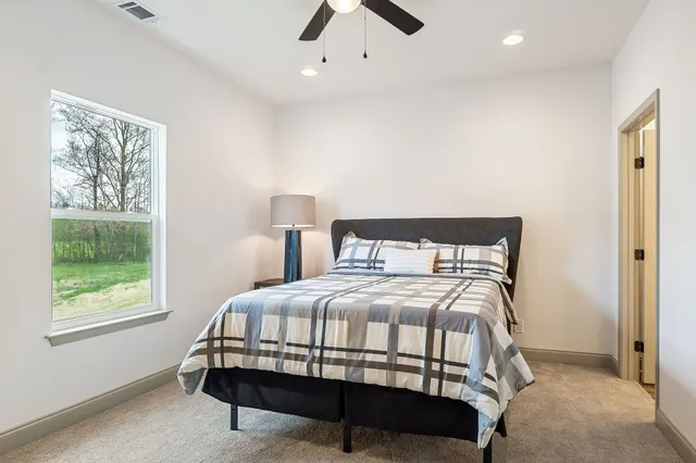 a bedroom with a bed and a window