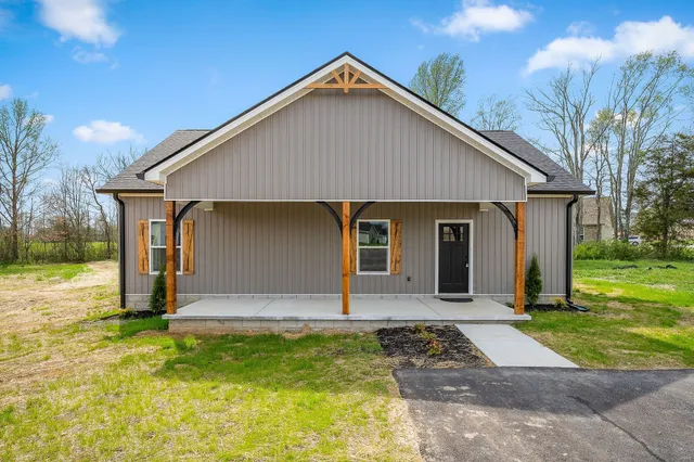 a front view of house with yard and green space