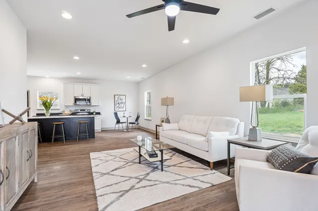 a living room with furniture and a large window