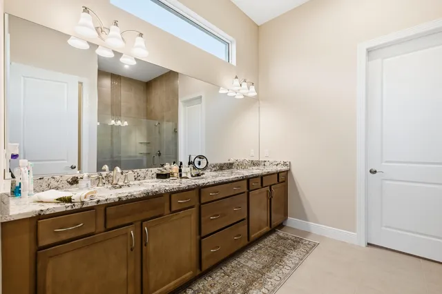 a bathroom with a double vanity sink and a mirror