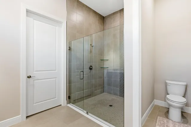 a bathroom with a shower and a toilet