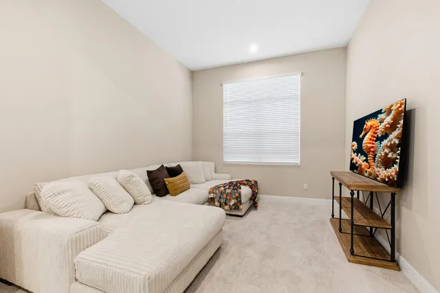 a bedroom with furniture and a window
