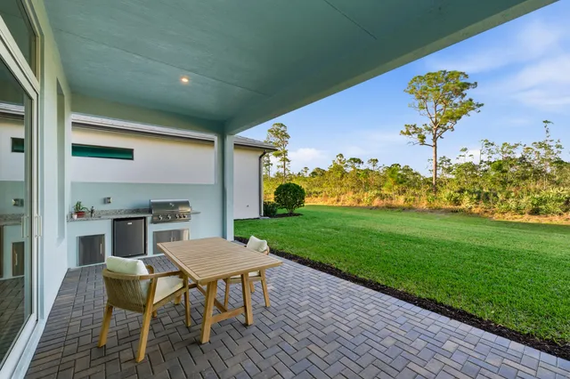 a view of a chairs and table in patio
