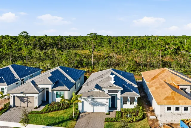 an aerial view of a house with a garden and outdoor seating