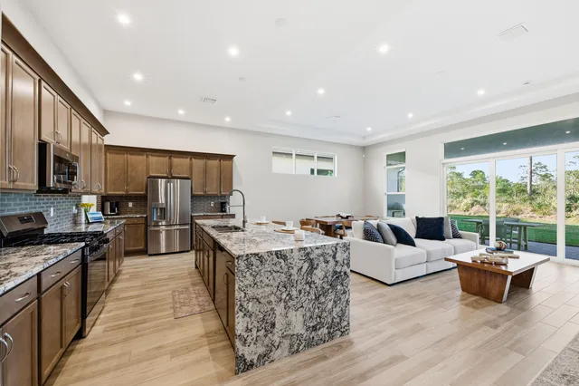 a living room with fireplace furniture and a large window