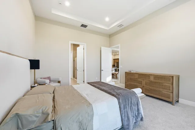 a bedroom with a bed and a night stand