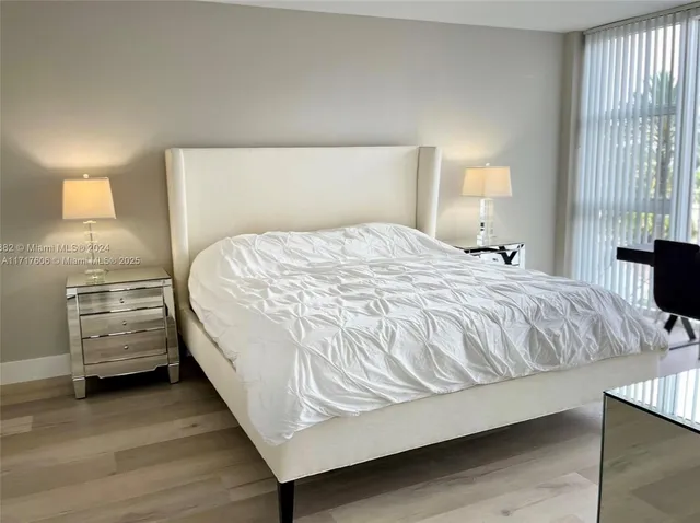 a bed sitting in a bedroom next to a lamp