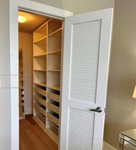 a view of closet area with empty racks