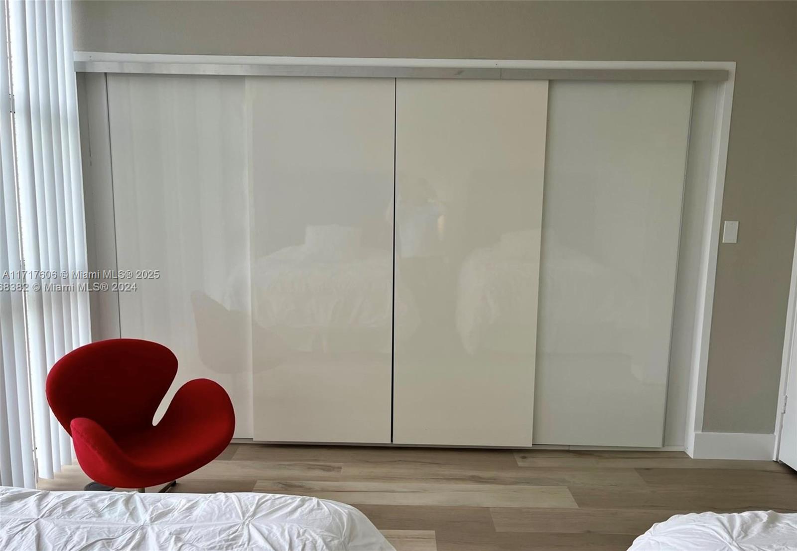 10275 Collins Avenue, Unit 331 Bal Harbour, FL 33154 - Photo 14 of 15 a view of a room with wooden floor and glass cabinet